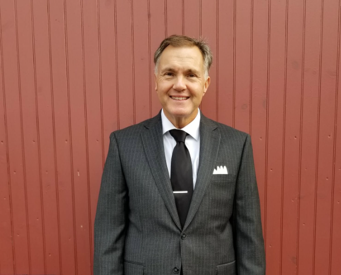 Ed Witles, founder and lead DJ of The Elegant DJ, in a charcoal suit