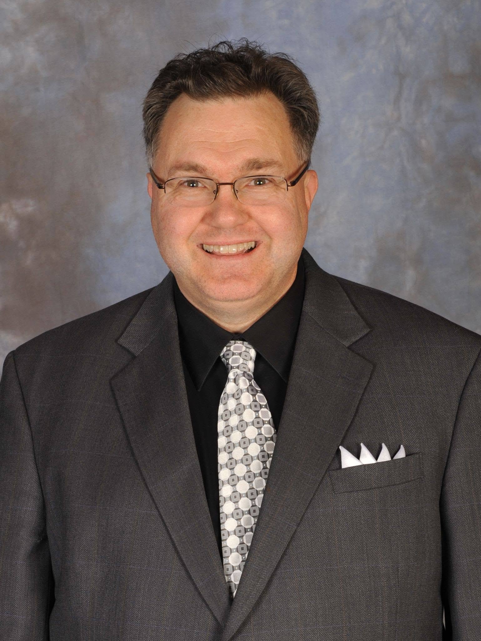 Ed Witles, founder and lead DJ of The Elegant DJ, in a charcoal suit